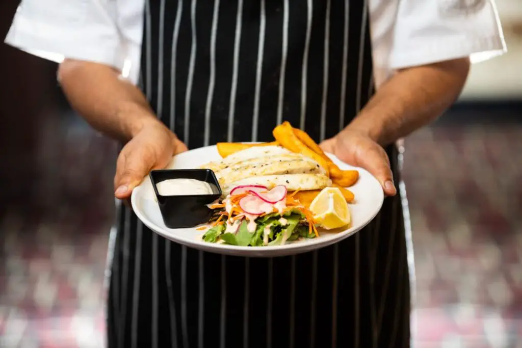 a chef holding a nutritious meal with necessary daily nutrients