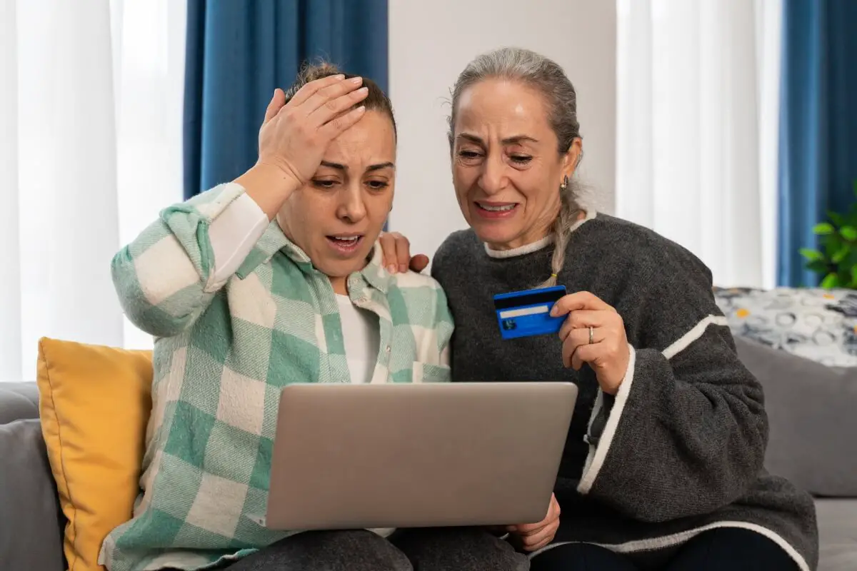 An elderly woman and her daughter or friend realize she fell victim to an online shopping scam