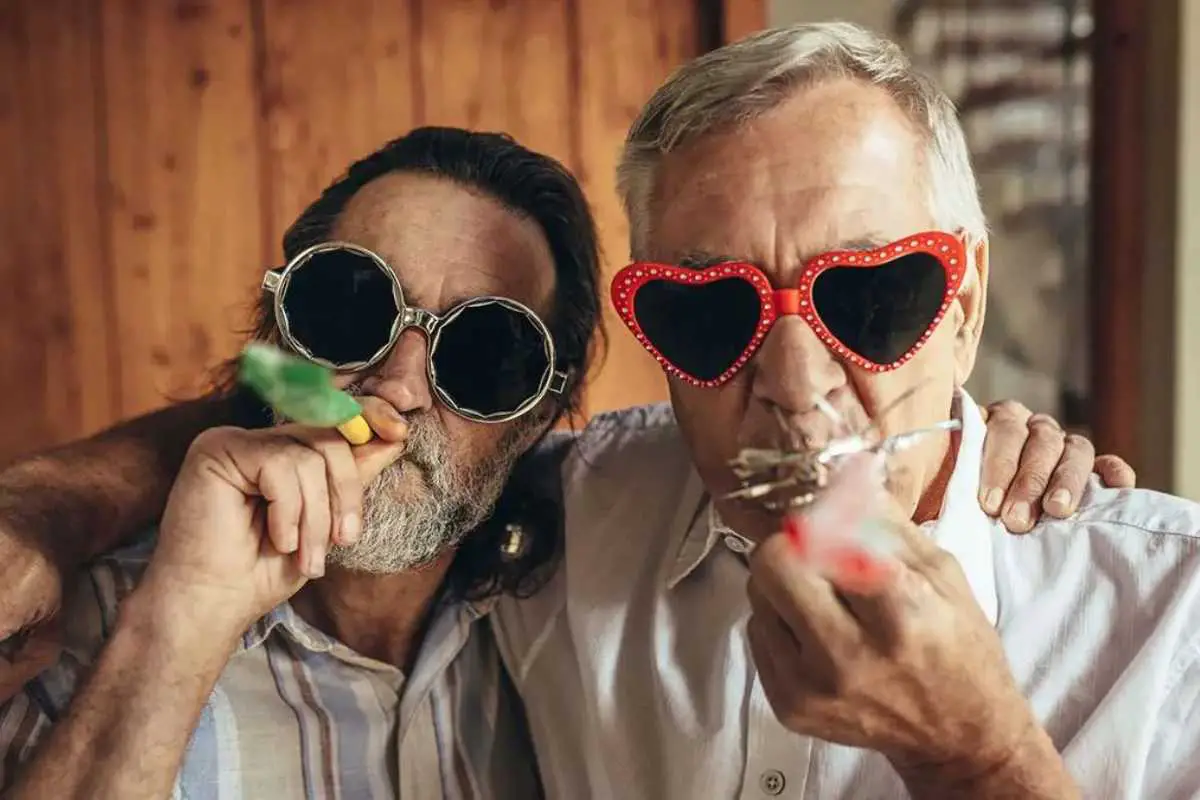 best gifts to give older adults this holiday season feature image of two elderly friends with sunglasses on, celebrating!