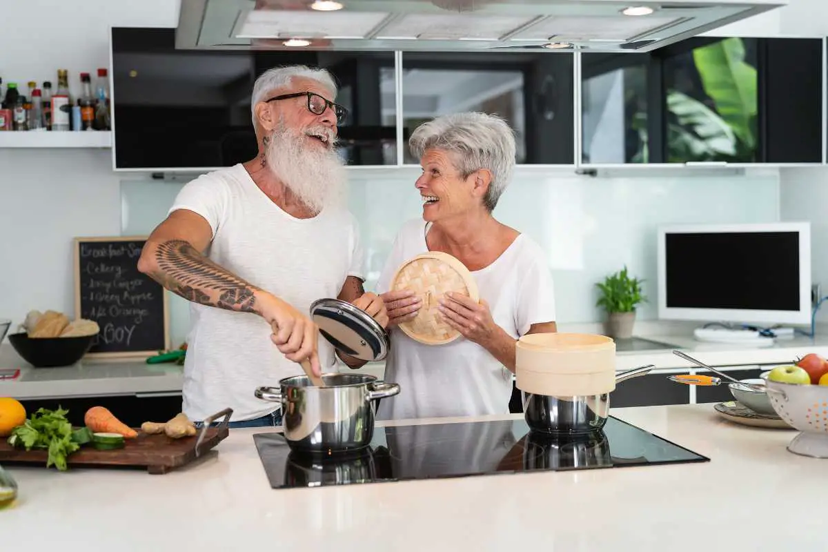 elderly people enjoying time spent together in the kitchen as a way to stay connected with each other