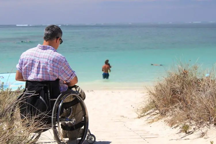 Man in a wheelchair at the beach