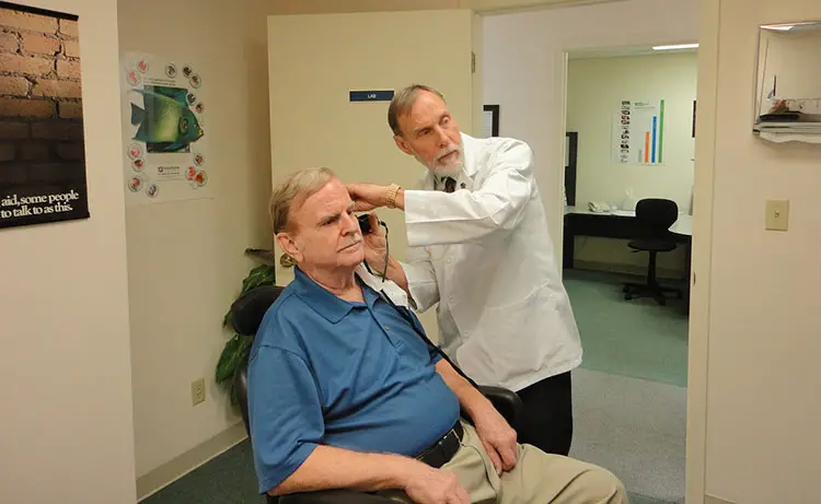 older man receiving a hearing test