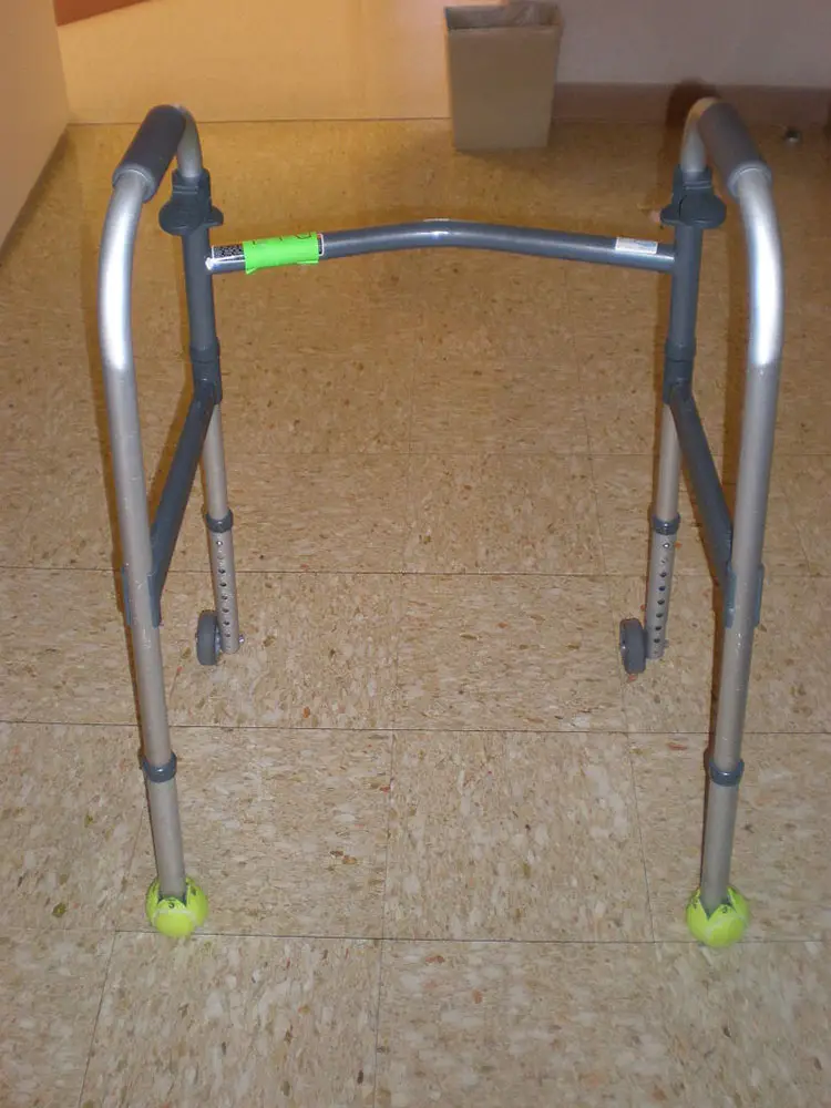 tennis balls installed on a walker