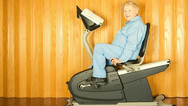 elderly woman exercising on bike