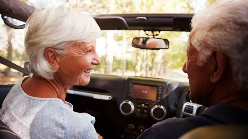 senior couple driving with car swivel seats