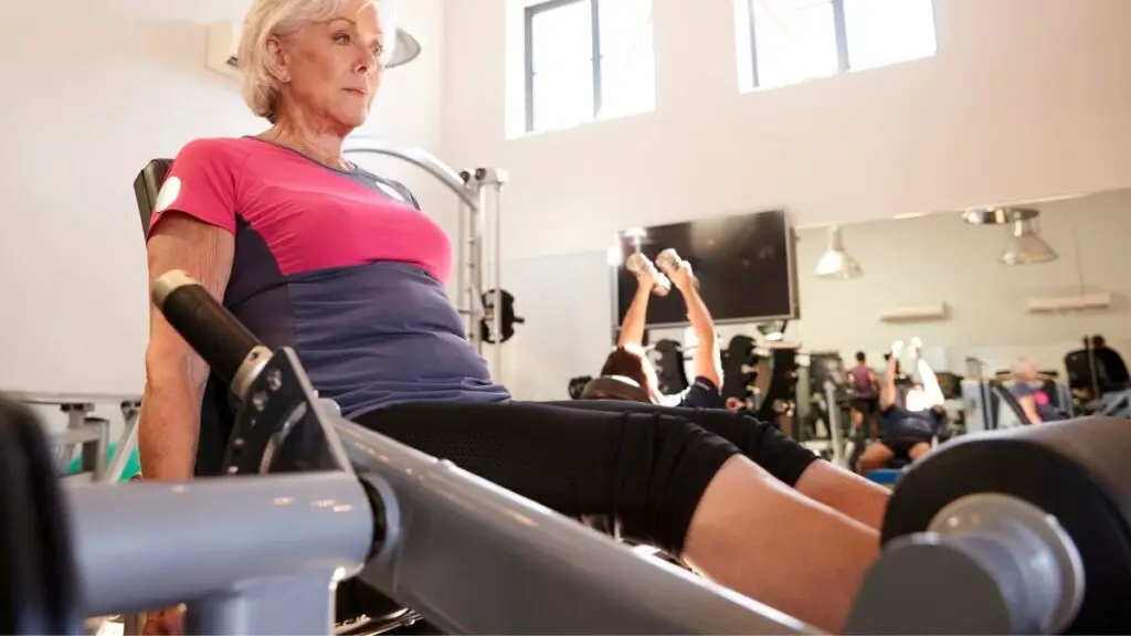 woman working on exercise equipment for seniors