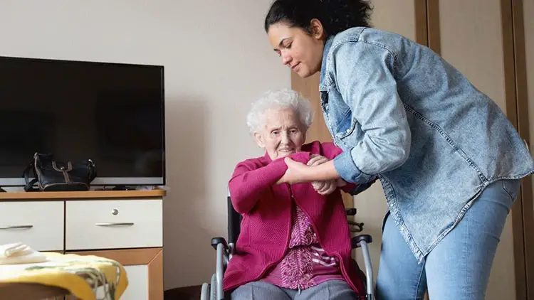 senior woman getting support from caregiver