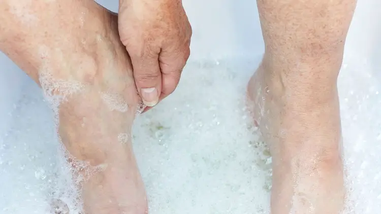 senior woman washing her feet