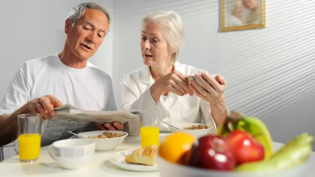 senior couple having high calorie breakfasts
