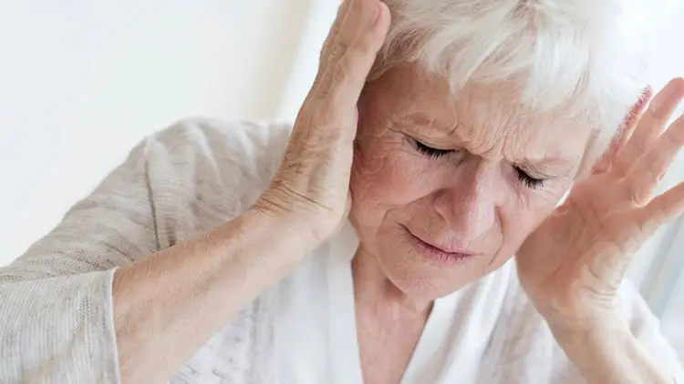 senior woman having tinnitus pain