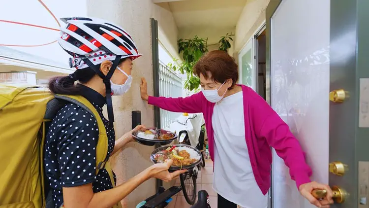 senior woman receiving food delivery