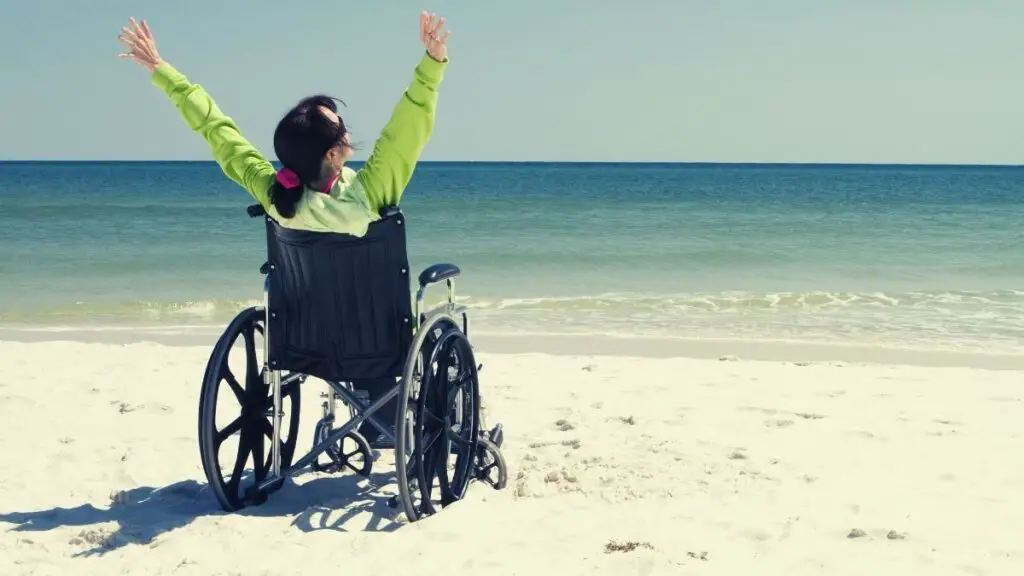 disabled woman at beach in a standard wheelchair