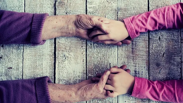 grandparent and grandchild holding hands