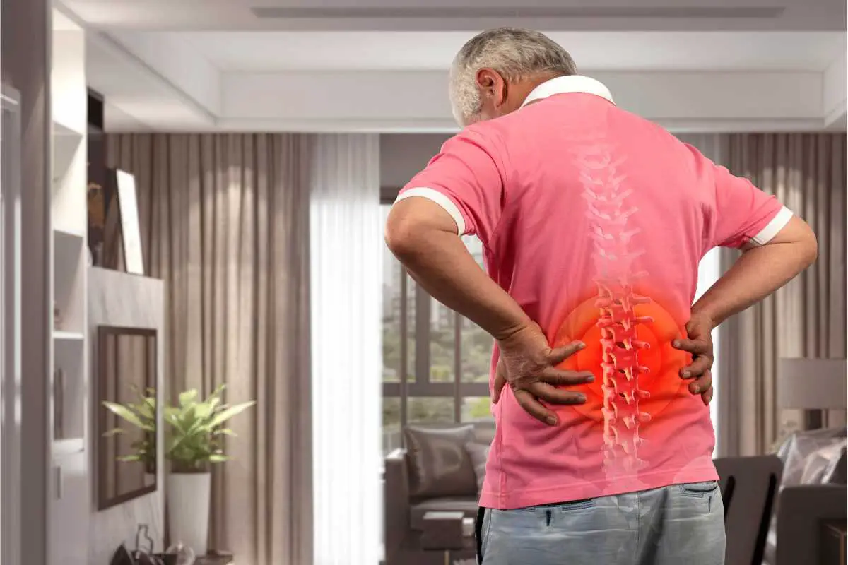 back pain or injury shown on an older man needing extra comfort from the kitchen chairs in his home