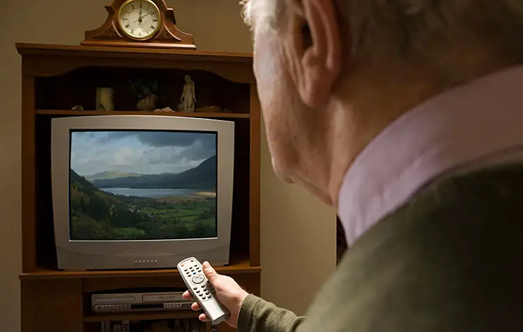 old man with dementia watching television