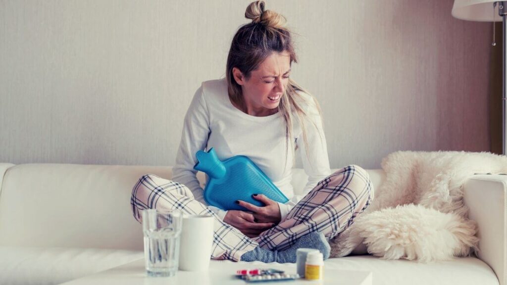 woman using hot water bottle for cramps