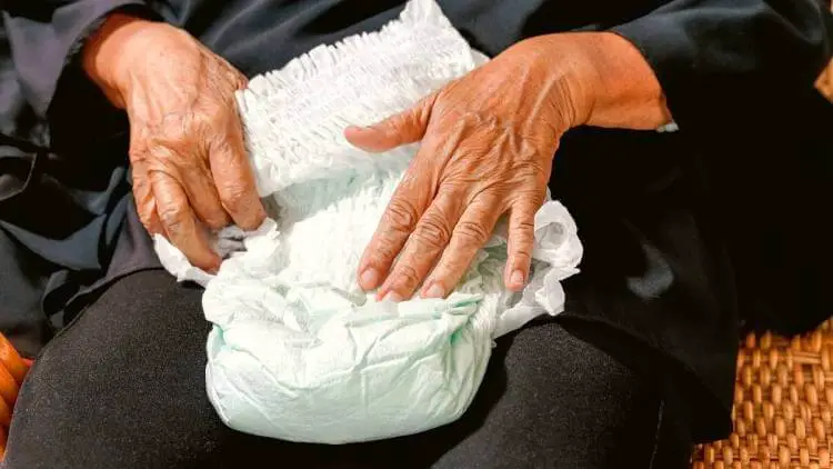 elderly woman holding diaper