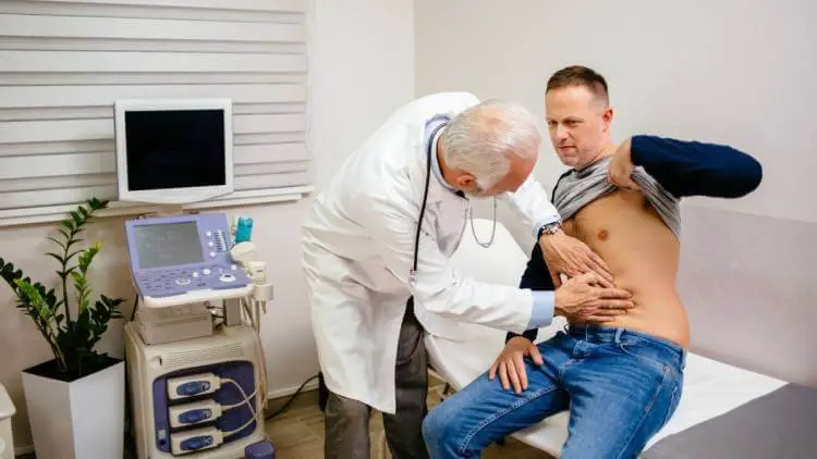 doctor examining a patient for stomach ulcer