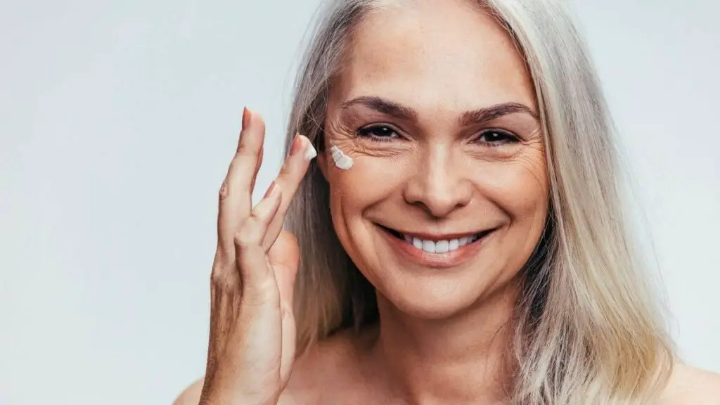 senior woman applying anti-aging skin toners