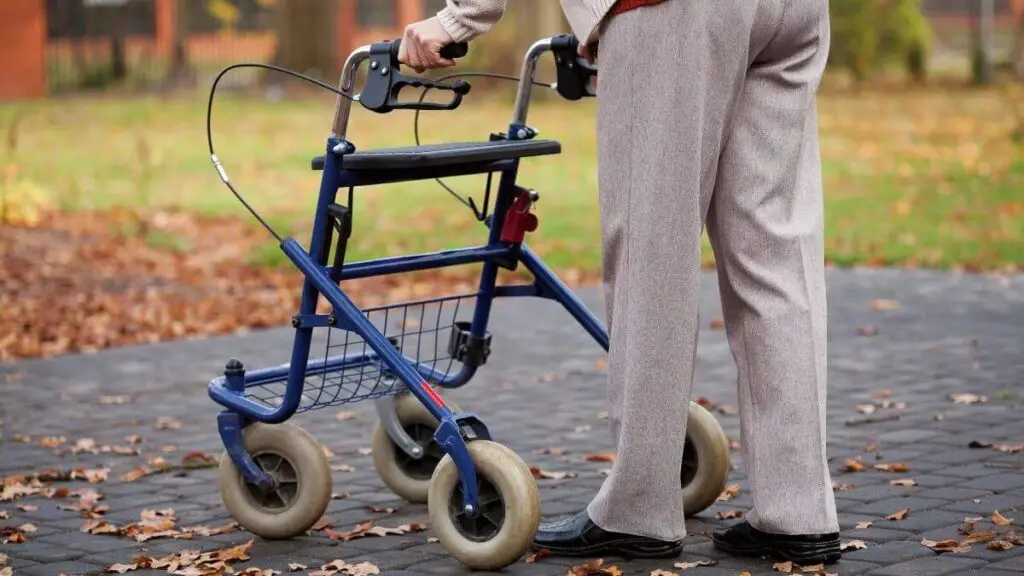 elderly person walking with walker