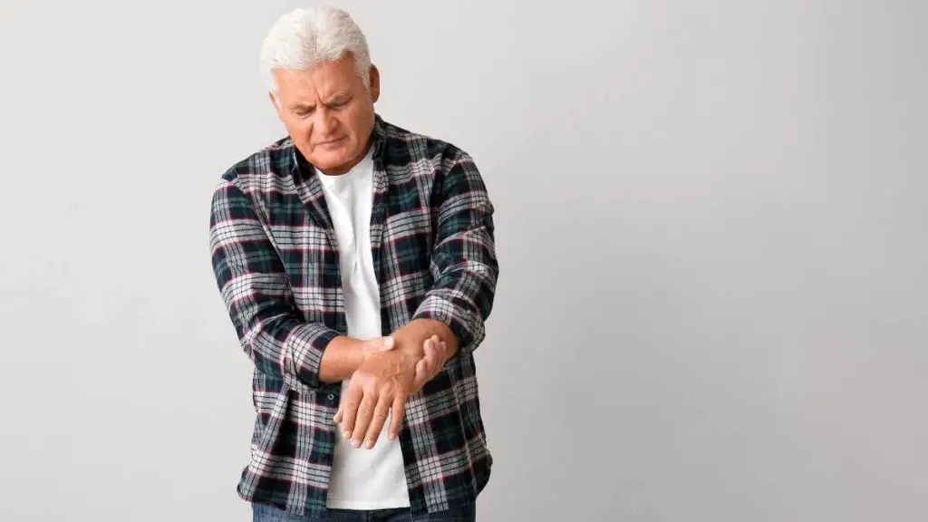 senior man suffering from hand tremor - old people shake feature image