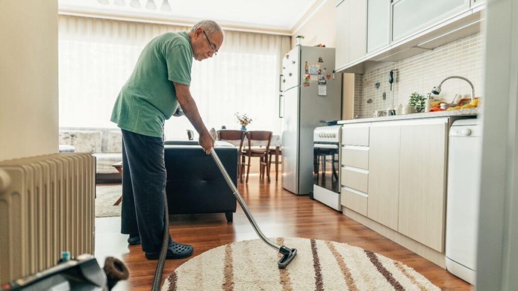 lightweight vacuum cleaners for seniors - elderly man vacuuming