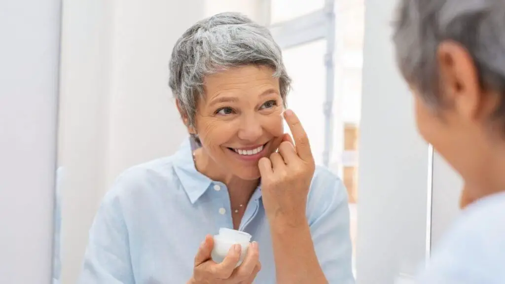 woman applying anti-aging skin care lotion