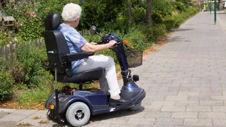 senior women driving a mobility scooter