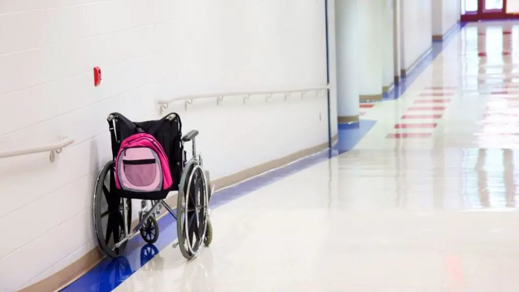 backpack hanging on wheelchair