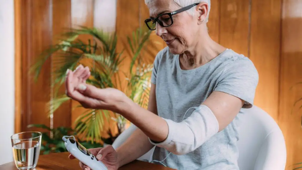 senior woman doing elbow therapy with TENS