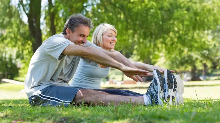 couple stretching in park
