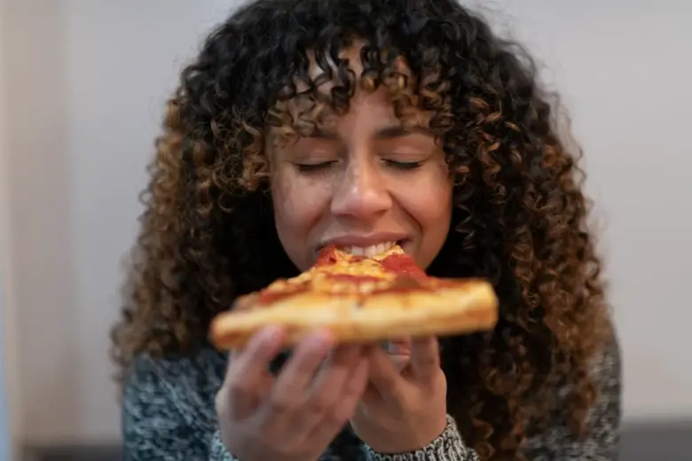 woman eating a pizza