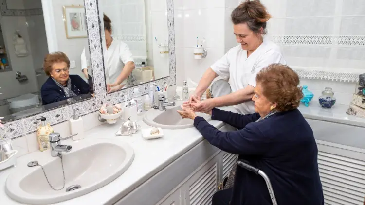caregiver helping to clean hands