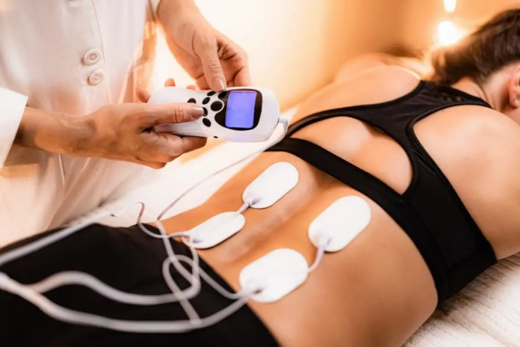 doctor demonstrating how to use a TENS unit