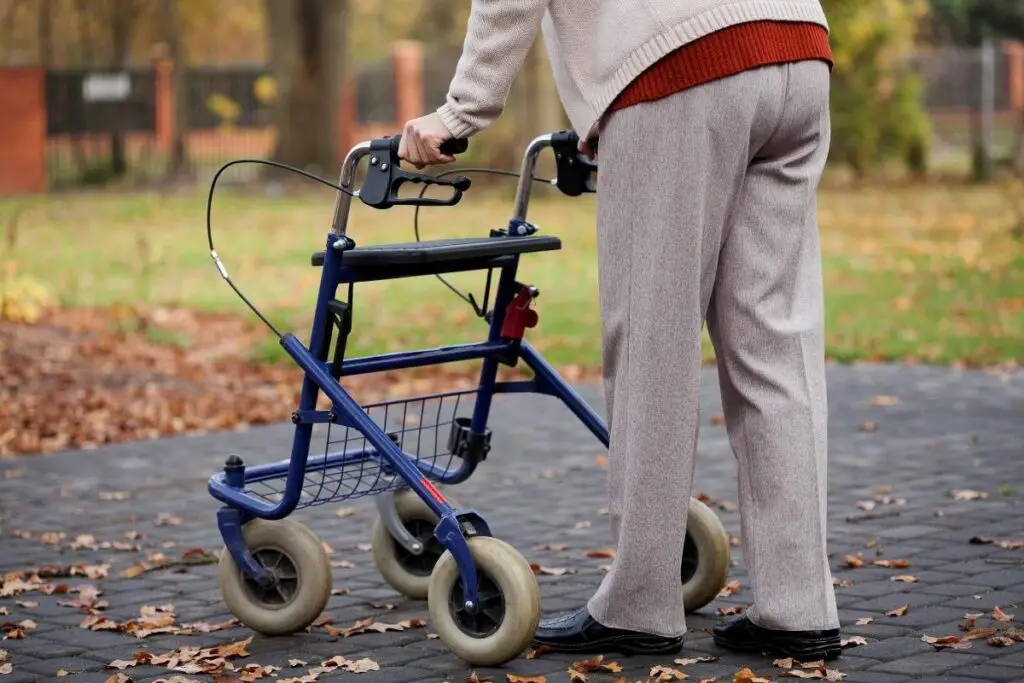 elder person walking with an upright walker