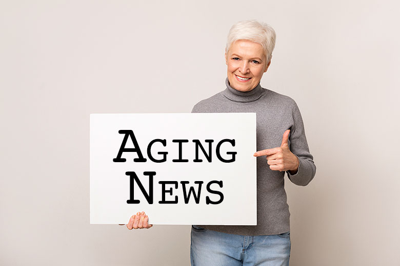 woman holding aging news sign