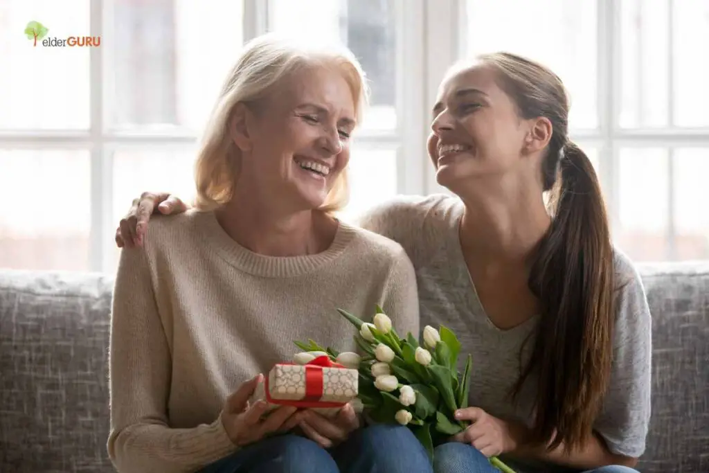 a granddaughter giving grandma mother's day gifts specially picked out for her - sterling silver jewelry wrapped in a box and some flowers