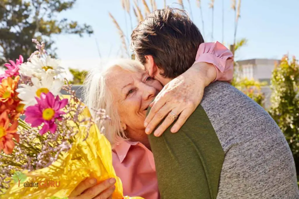 a grandson giving his grandmother a hug and some flowers - the perfect way to show love and appreciation
