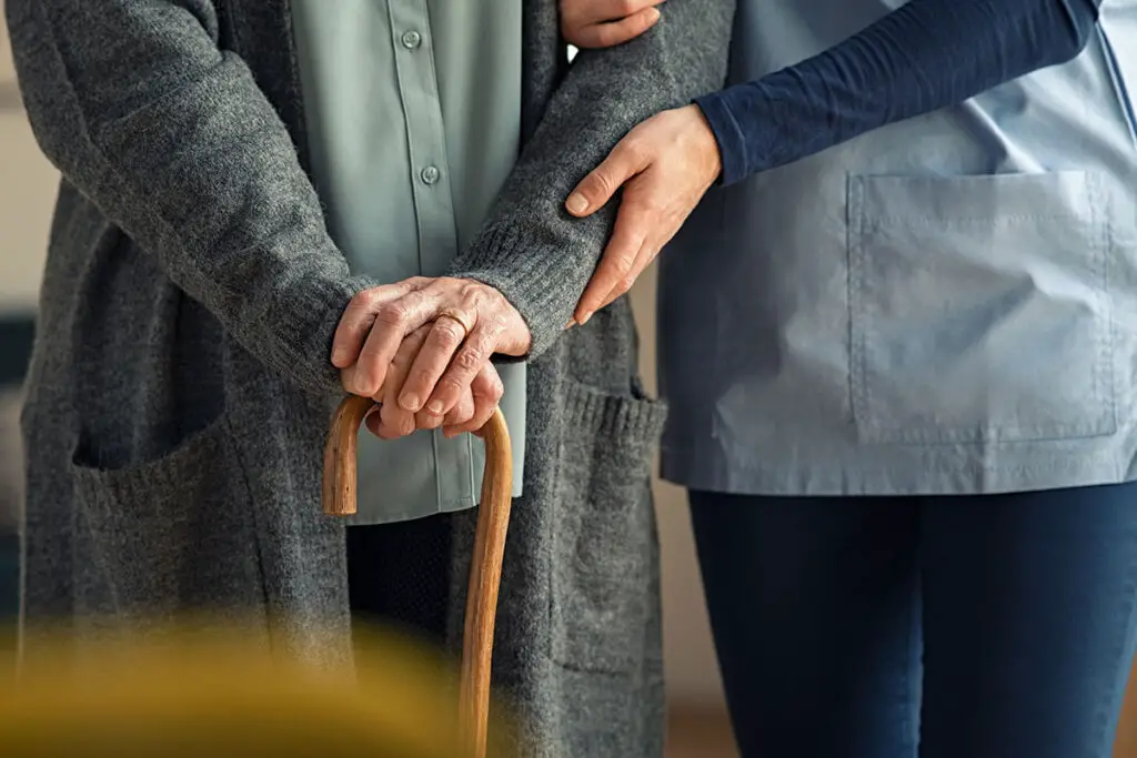 senior holding a walking stick