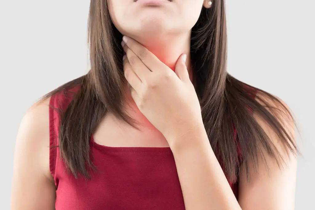 woman struggling with how to cure a sore throat
