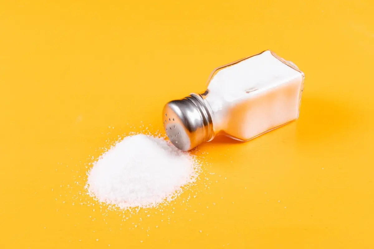 why everything can taste salty feature photo of yellow background with spilled white salt