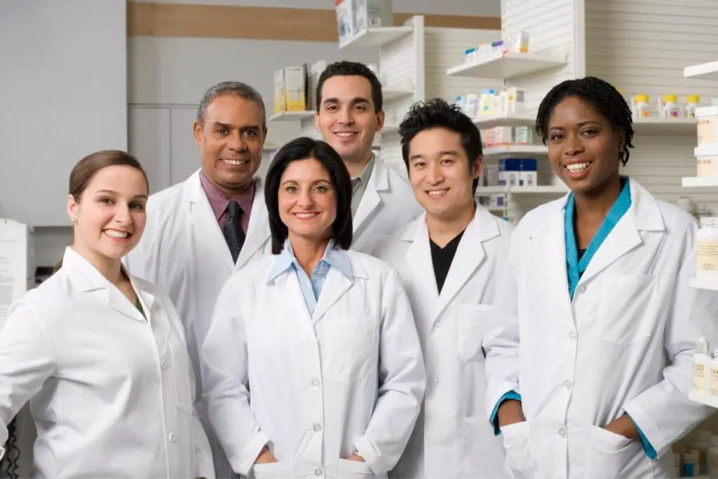 5 pharmacists of various ages and ethnicities standing together