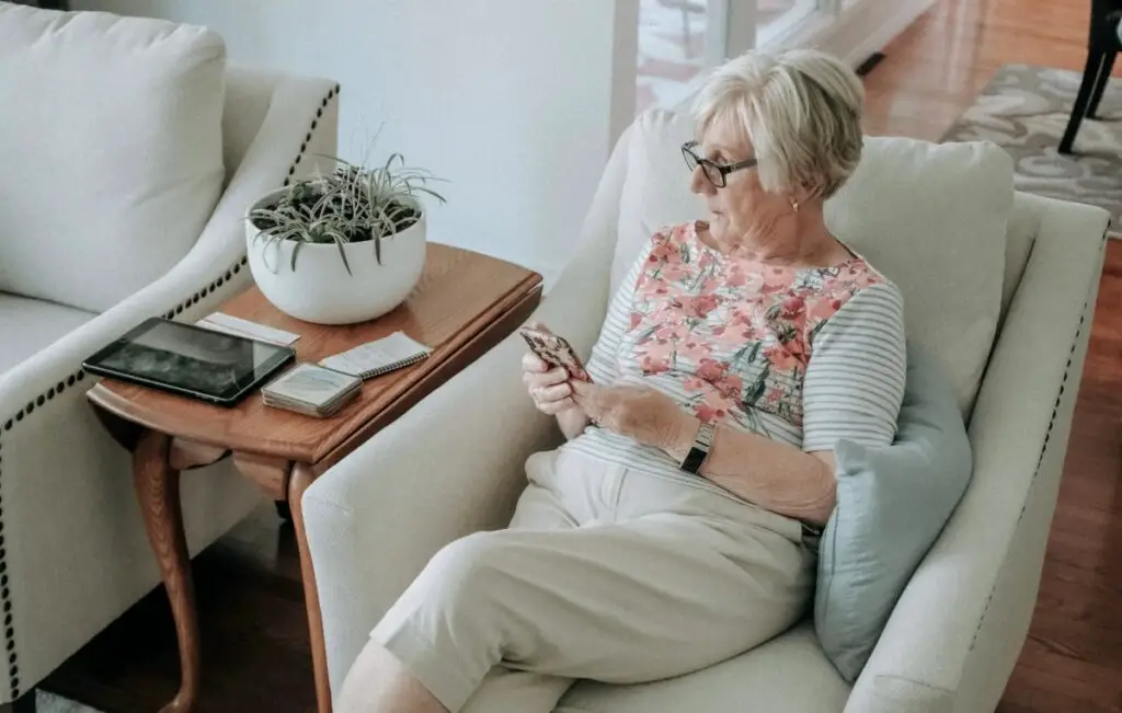 A woman sitting in a comfortable chair for watching television.