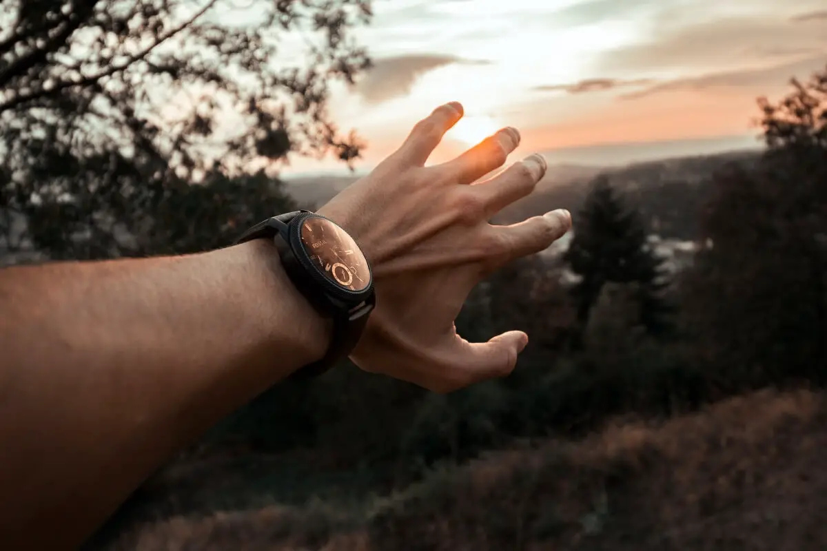 an outstretched hand wearing a watch with built in fall detection, including a fall detection sensor, that can reach out to emergency contacts if needed