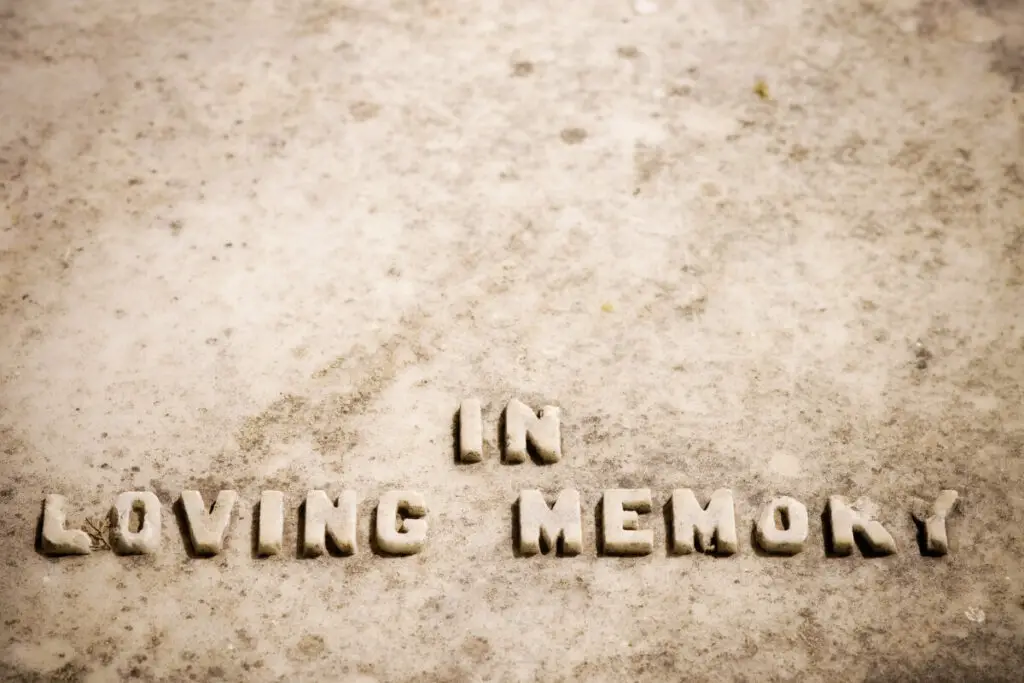 a few words written in sand - 'in loving memory' of a grandmother's life