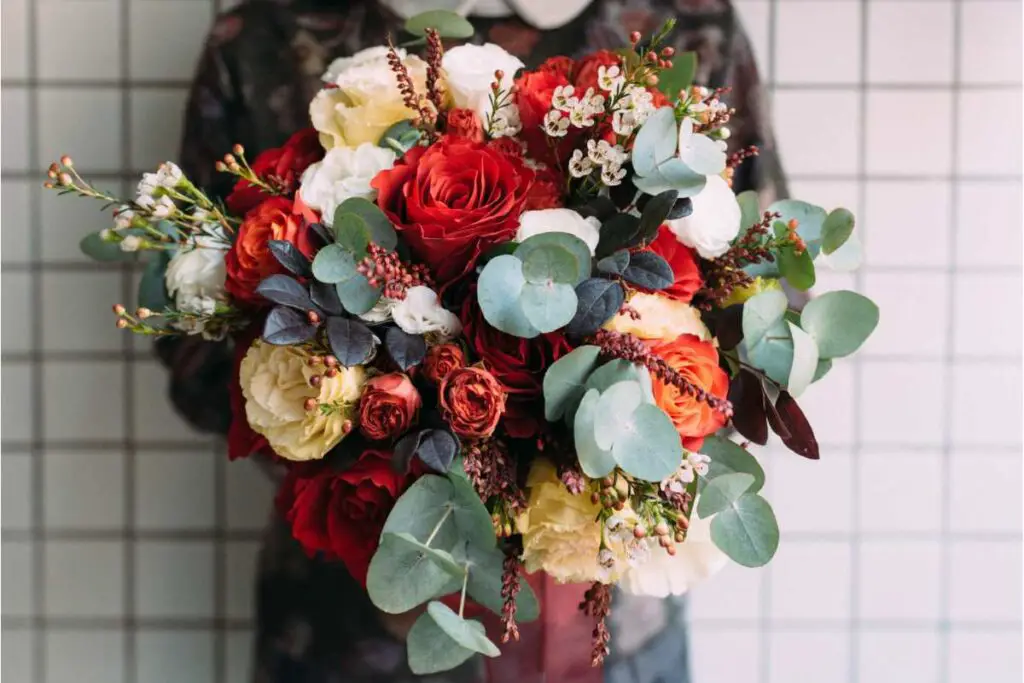 a friend offering condolences via a bouquet of flowers to someone who has recently lost a loved one as a way of showing support