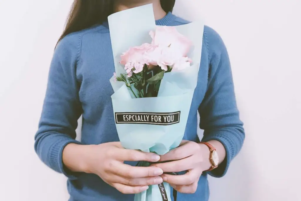 a friend offering love and support with flowers during a sad time