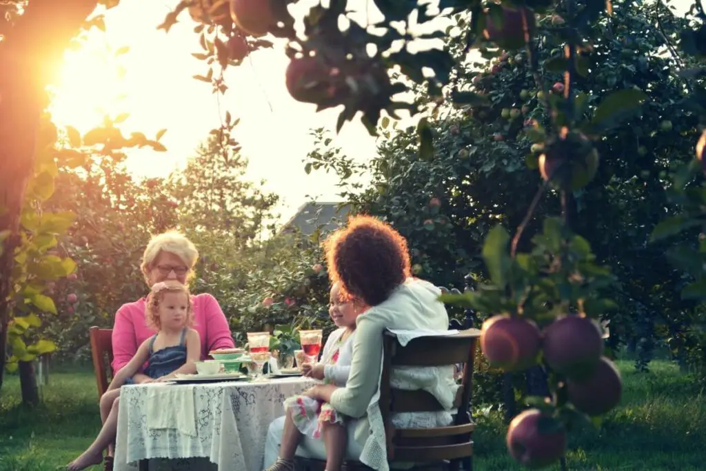 a grandma sharing sage advice with her family while enjoying a meal outside