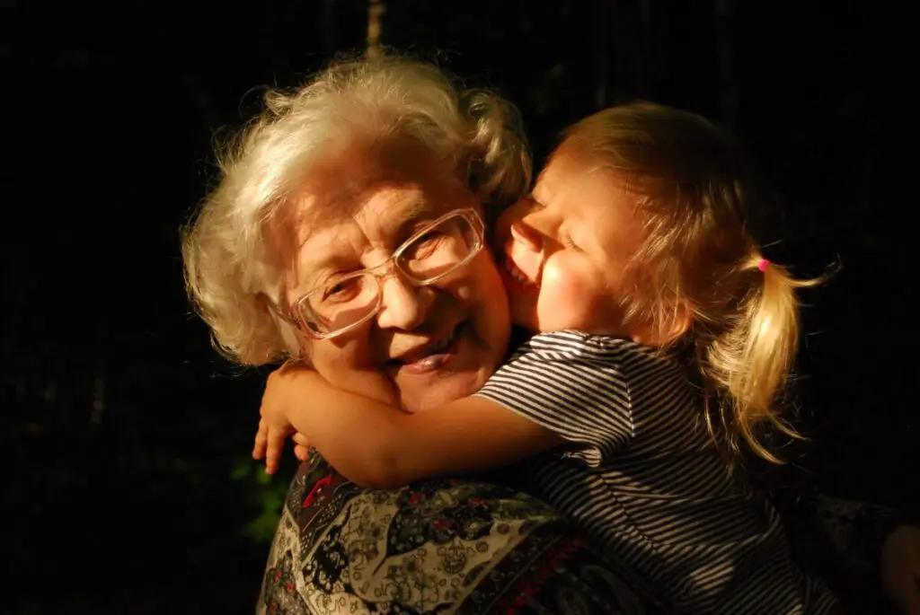 a young granddaughter with her arms wrapped around a special woman - her inspiration, her grandmother