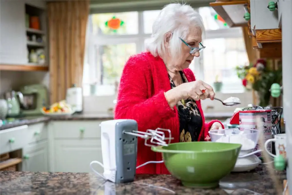 an elderly parent that's completed the elder care checklist, enjoying baking in her own home rather than senior living communities